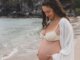 Photo of Michelle, of Mindful with Michelle, pregnant on the beach
