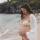 Photo of Michelle, of Mindful with Michelle, pregnant on the beach